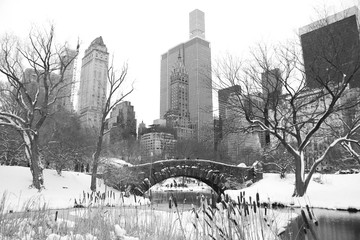 Gapstow bridge with snow at Central Park and buildings of Manhattan in black and white style