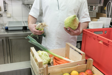 Chef inspecting food delivery to his restaurant kitchen