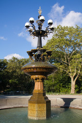 Cherry Hill fountain with trees blue sky in summer at Central Park