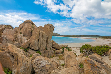 Fototapeta na wymiar Rocks in crystal clear sea water of Villasimius beach, Sardinia island, Italy