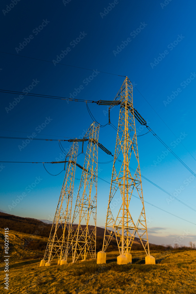 Poster electricity pylons at sunset