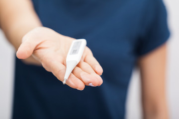 Sick women with a thermometer