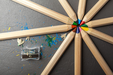 colorful pencils on gray stone background