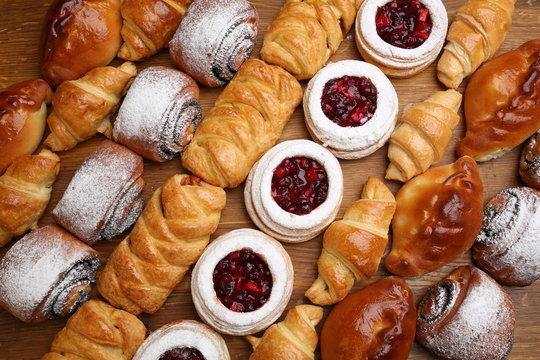 Sweet pastries, puff pastry, powdered sugar, nuts, jams, baked apples.