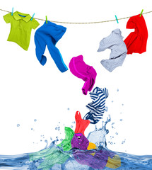Colorful clothes fly out of the water, isolated on white background.