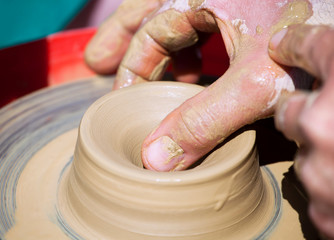 The man - Potter from the clay pitcher on a Potter's wheel.