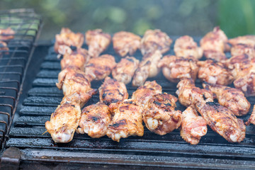Grilling chicken wings on grill