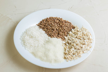 Rice, buckwheat, semolina and oat groats in glass jars. Useful and nutritious food.