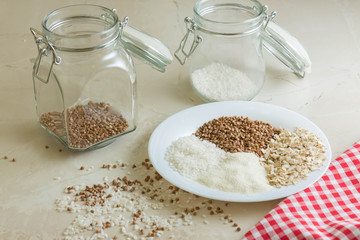 Rice, buckwheat, semolina and oat groats in glass jars. Useful and nutritious food.