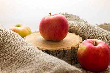 Red apple on a stump. Delicious and ripe fruit.