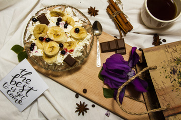 Cottage cheese and banana slices on a plate, top view