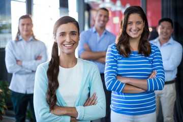 Portrait of businesspeople standing with arms crossed