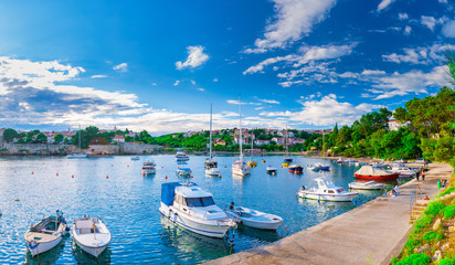 Fototapeta premium Wonderful romantic summer evening landscape panorama coastline Adriatic sea. Boats and yachts in harbor at cristal clear azure water. Old town of Krk on the island of Krk. Croatia. Europe.