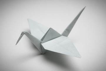 White Crane. Folded paper craft origami bird. Symbol of peace, luck and happiness - obrazy, fototapety, plakaty