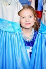 little girl among dresses