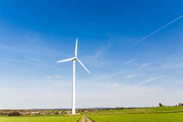 Fototapeta na wymiar Wind turbine with blue sky - renewable energy