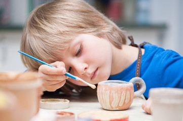 boys make a product made of ceramics