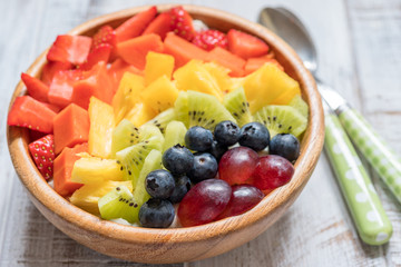 Breakfast oatmeal for kids topped with rainbow fruits