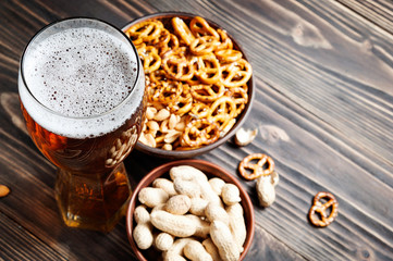 Beer with pretzels, saltsticks and peanuts. Viewed from above with copyspace.