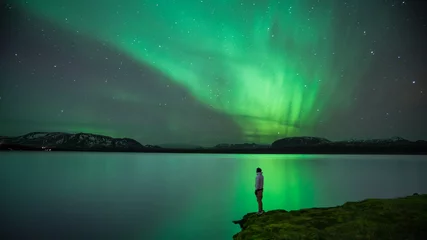 Wall murals Northern Lights Man with Northern Lights reflection