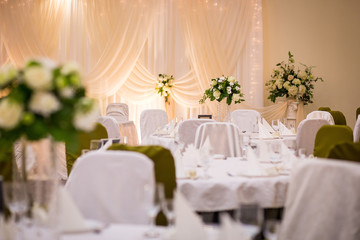 Plate at the wedding table,Wedding table settings.Wedding table that decorated with flower arrangements,Wedding. Banquet.Wedding flower composition for guests tables