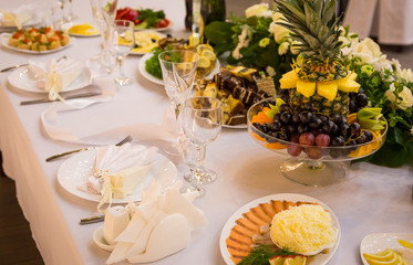 Plate at the wedding table,Wedding table settings.Wedding table that decorated with flower arrangements,Wedding. Banquet.Wedding flower composition for guests tables