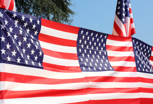 Series of American flags with blue sky