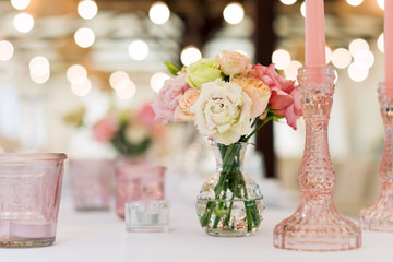 Flower table decorations for holidays and wedding dinner. Table set for holiday, event, party or wedding reception in outdoor restaurant.