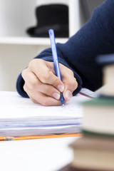 closeup of the hand of the child writing with the pen