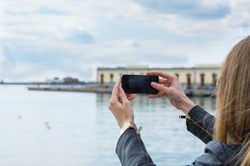 girl taking photo with cellphone