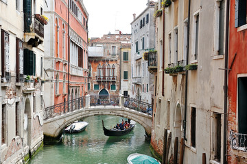 Fototapeta na wymiar Venice, Italy - picturesque view of a canal, buildings, gondola and bridge