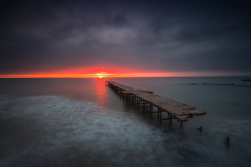 Sunrise over the broken sea bridge