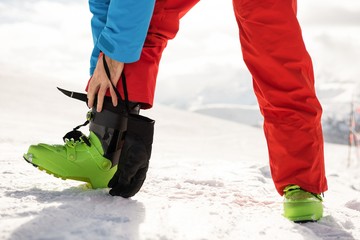 Skier tying his boot strap
