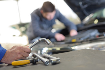 a young mechanic running a diagnostic test on a car