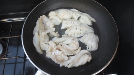 fresh caught cod frying on outdoor grill