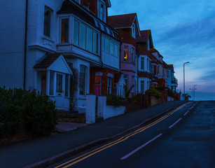Typical English architecture, residential buildings in line along the street, beautiful sunset