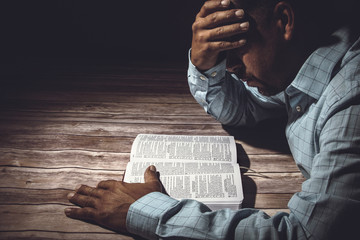 Worried man reading the Holy Bible - 150269373