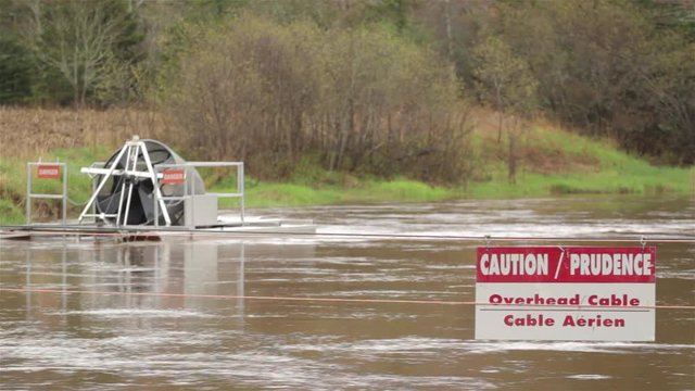 Caution sign and smolt wheel equipment on river