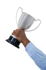 Hand of businessman holding trophy