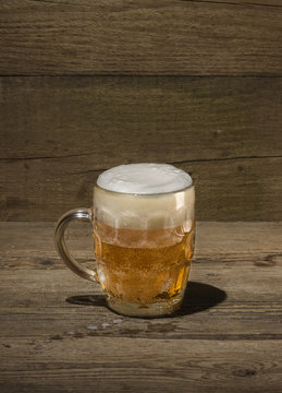 Glass of beer on the wood background