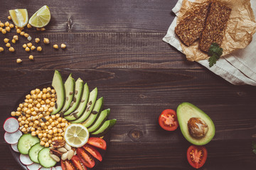 Healthy vegan food concept. Healthy food with vegetables and whole wheat bread on the wooden table top view