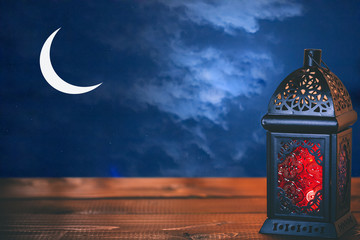 The Muslim feast of the holy month of Ramadan Kareem. Beautiful background with a shining lantern...