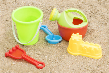 Fototapeta na wymiar colorful plastic toys for the beach on sand