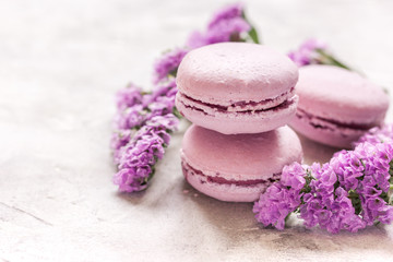 Fototapeta na wymiar spring woman breakfast with macaroons and mauve flowers white background