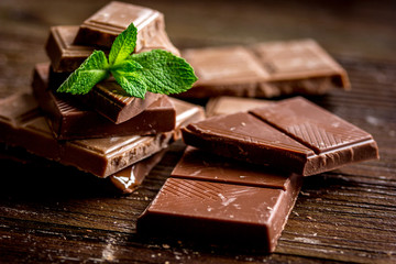 chocolate pieces with mint on wooden table background