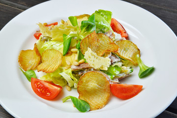 crunchy potato chips with cheese and salad