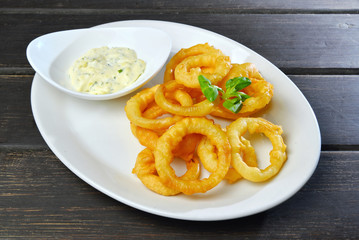 Homemade Fried Onion Rings with sauce on a plate