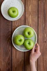 fresh organic green fruits with apples on wooden background top view