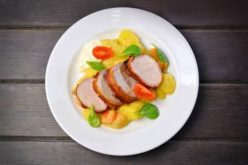 roasted sliced pork neck on wooden table top view