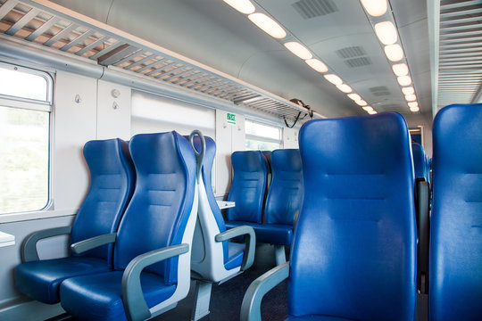 interior of a train wagon with empty seats